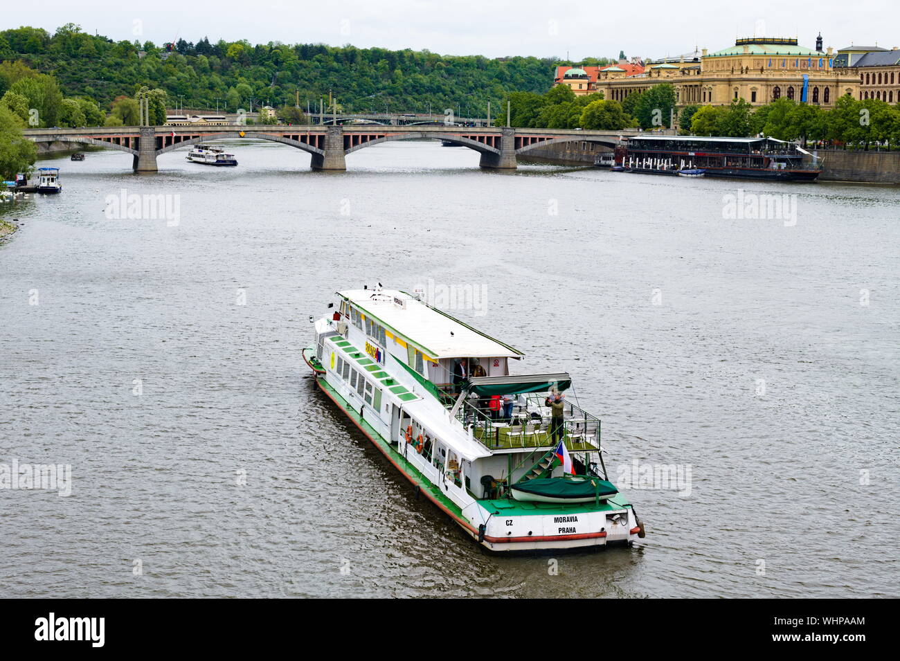 Vue sur un bateau sur la rivière Vitava avec le pont Mánes en arrière-plan, Prague, République tchèque Banque D'Images