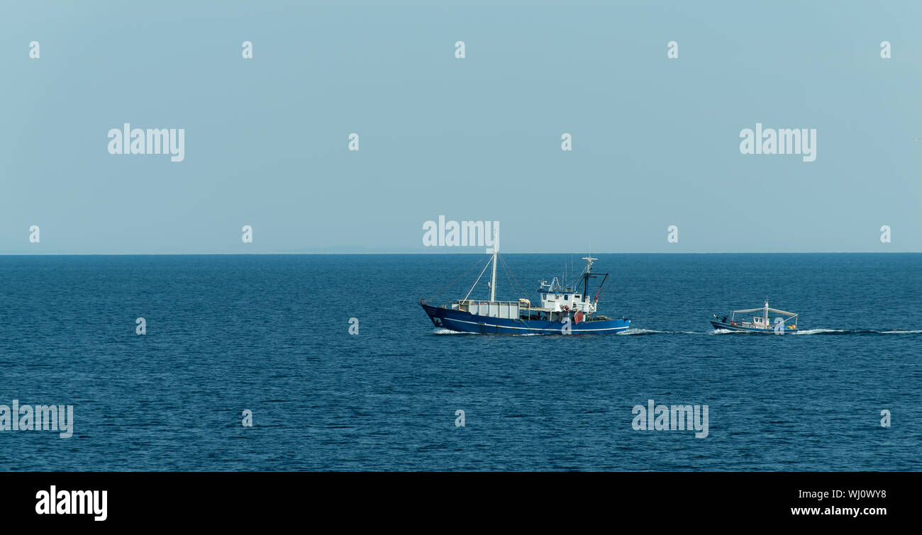 Petit bateau à remorquer un bateau dans la mer Banque D'Images