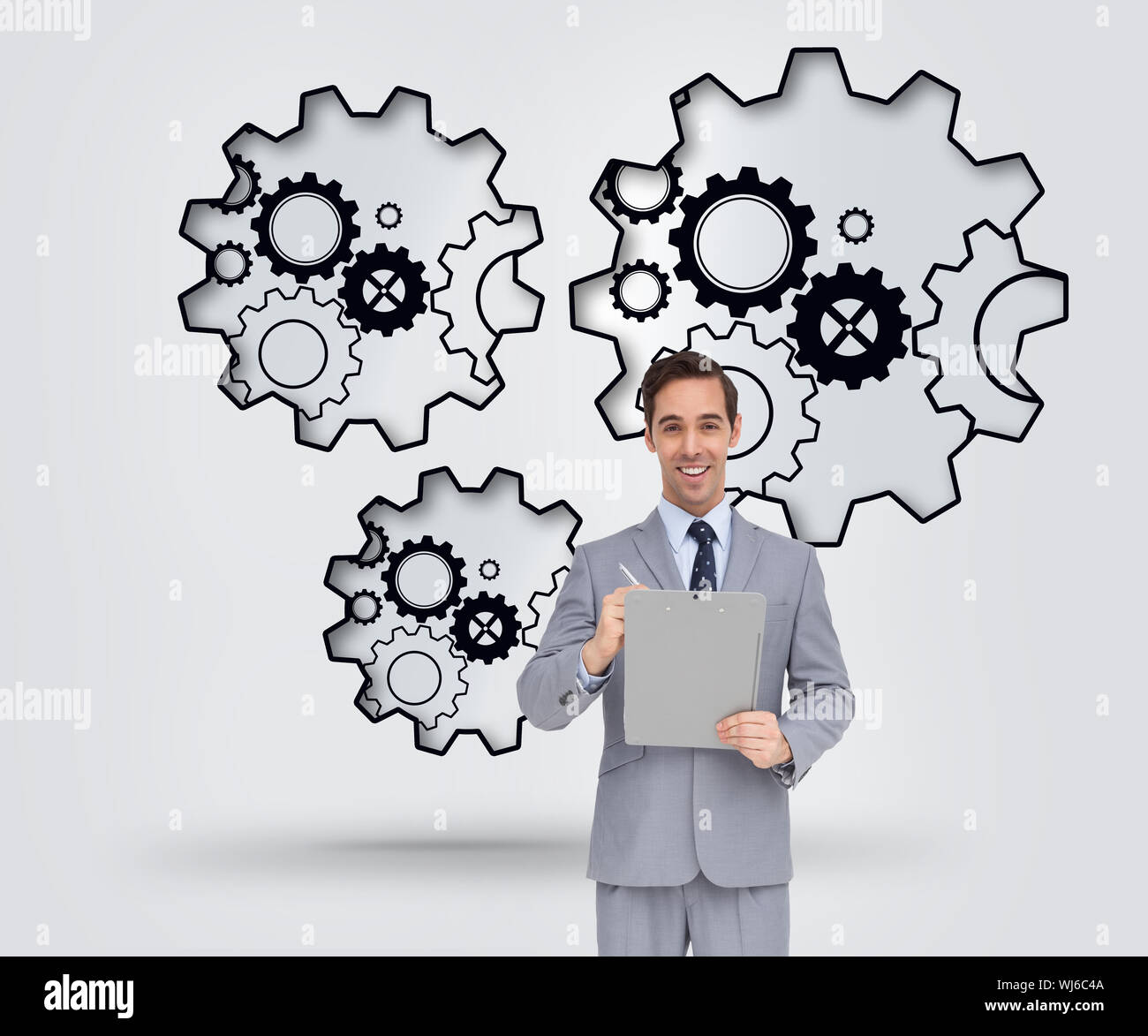 Composite image of businessman holding a clipboard Banque D'Images