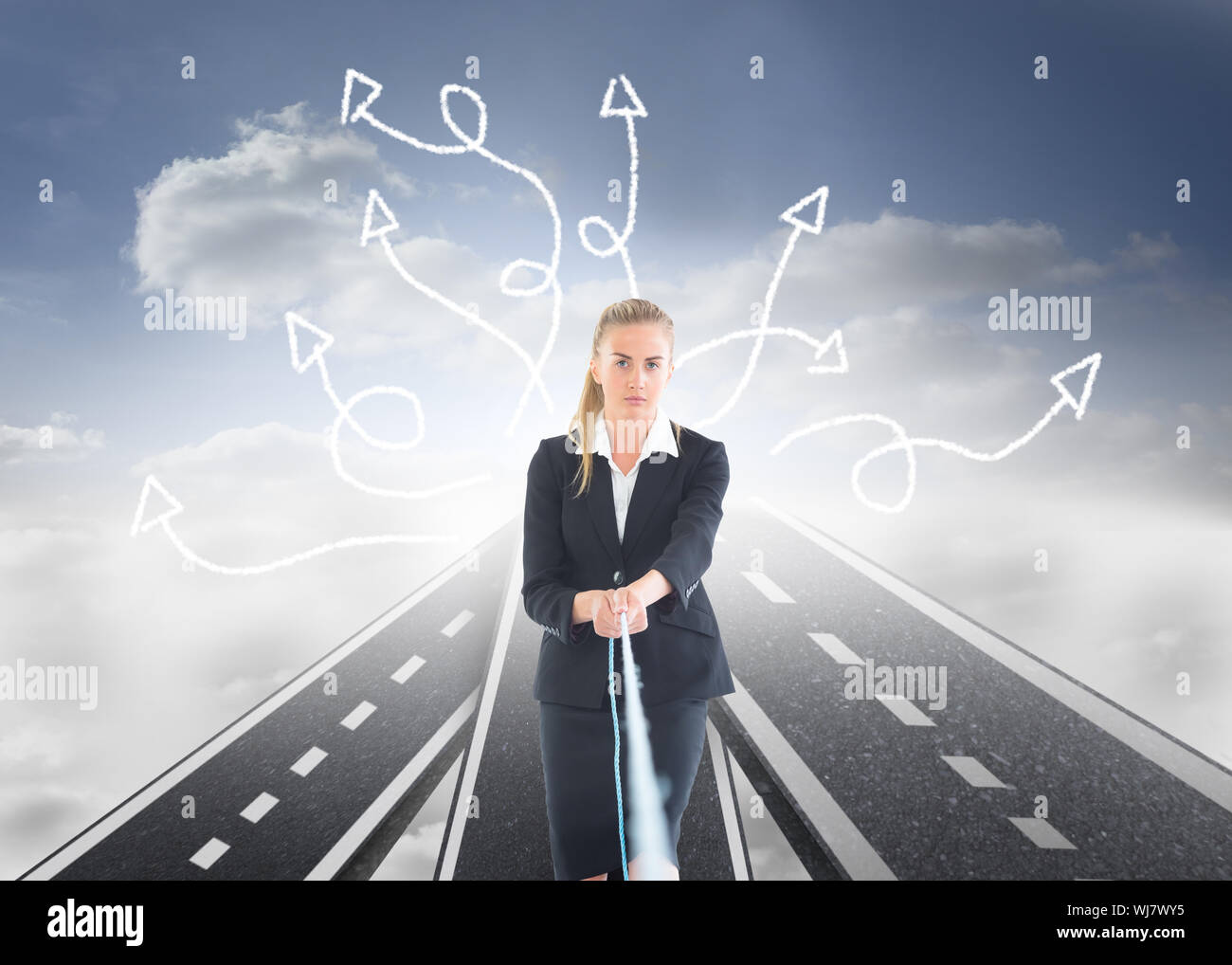 Image composite de blond businesswoman pulling a rope Banque D'Images