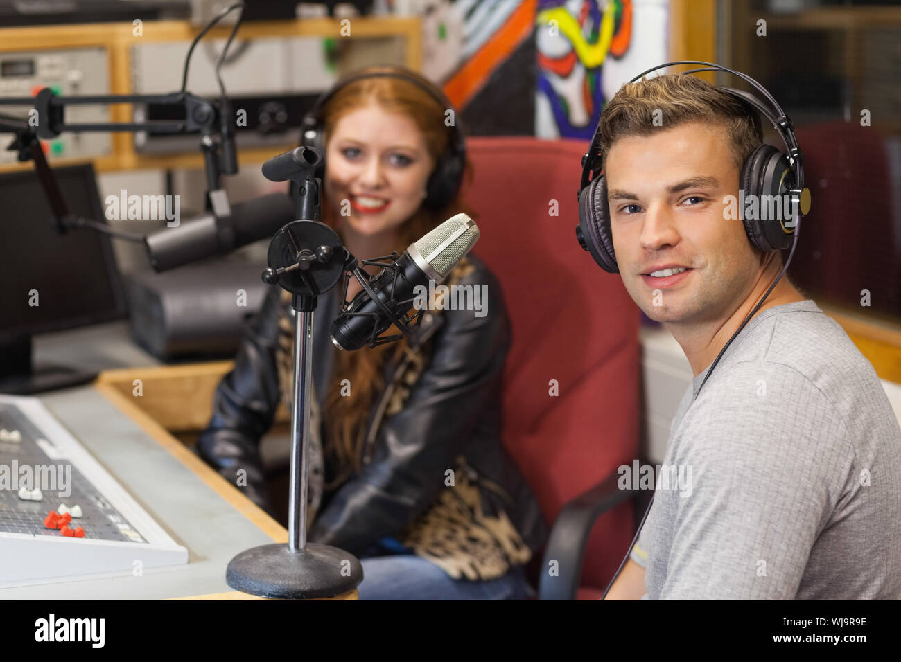 Cheerful attractive radio host interviewing a guest Photo Stock - Alamy
