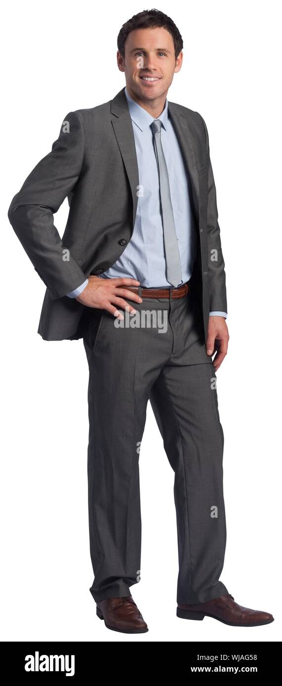 Smiling businessman with hand on hip Banque D'Images