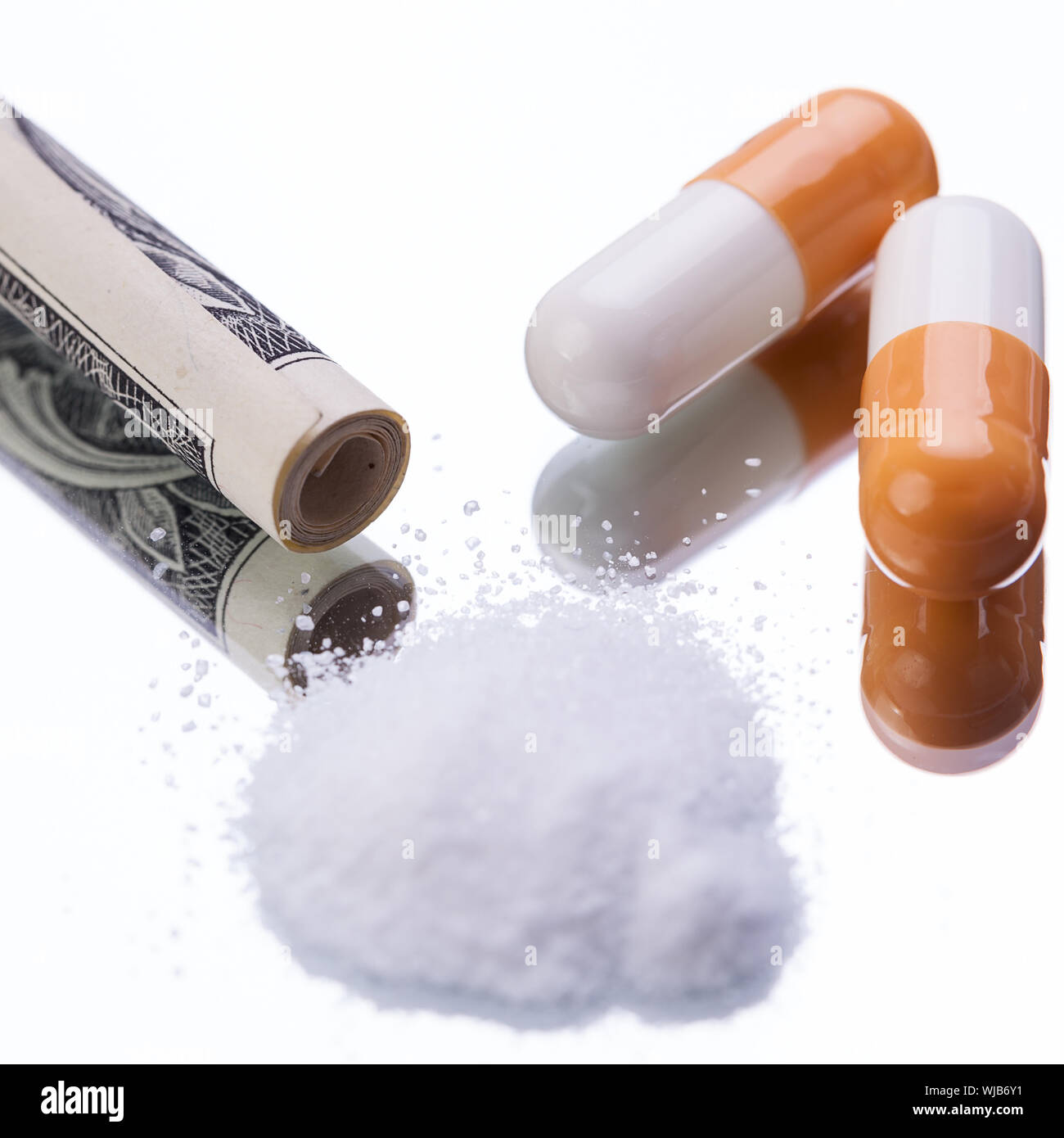Comprimés pharmaceutiques illégales et les drogues de l'argent sur miroir Banque D'Images