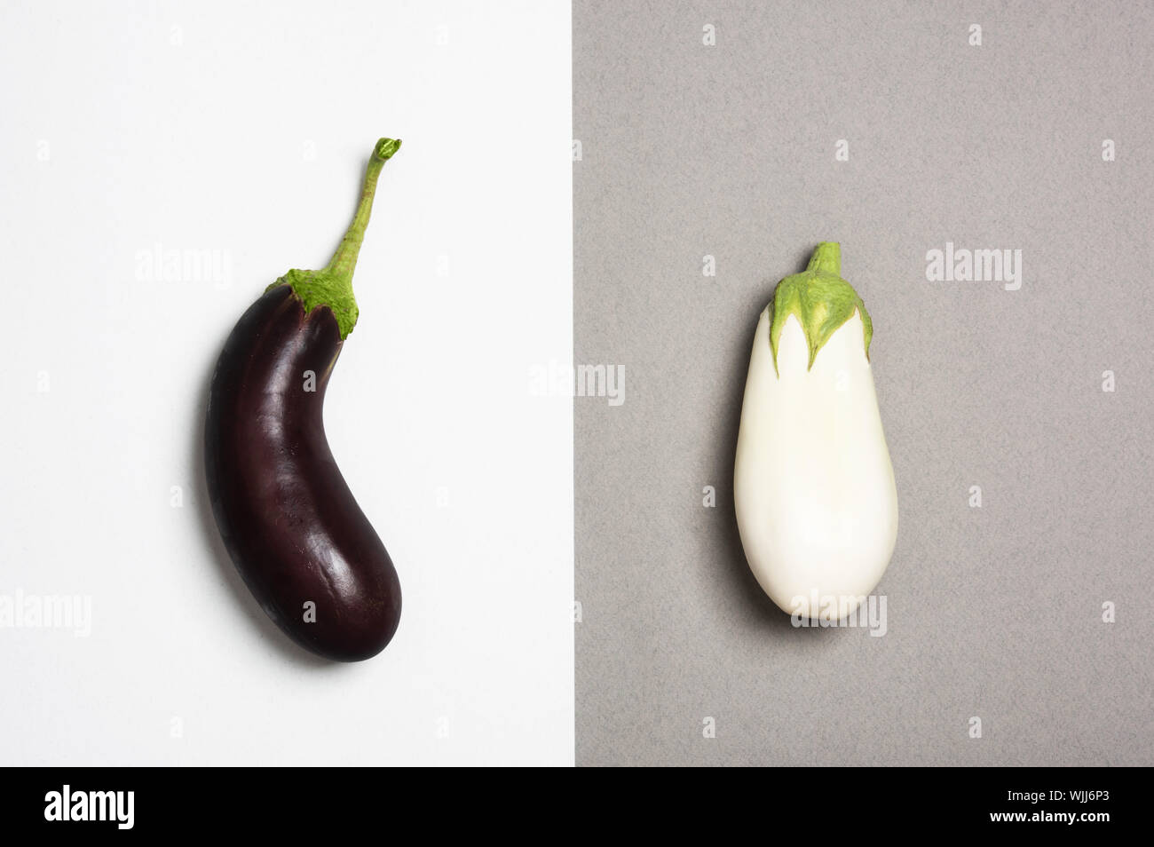 Sombre et aubergines blanches isolé sur fond duotone. Concept de différence. Banque D'Images