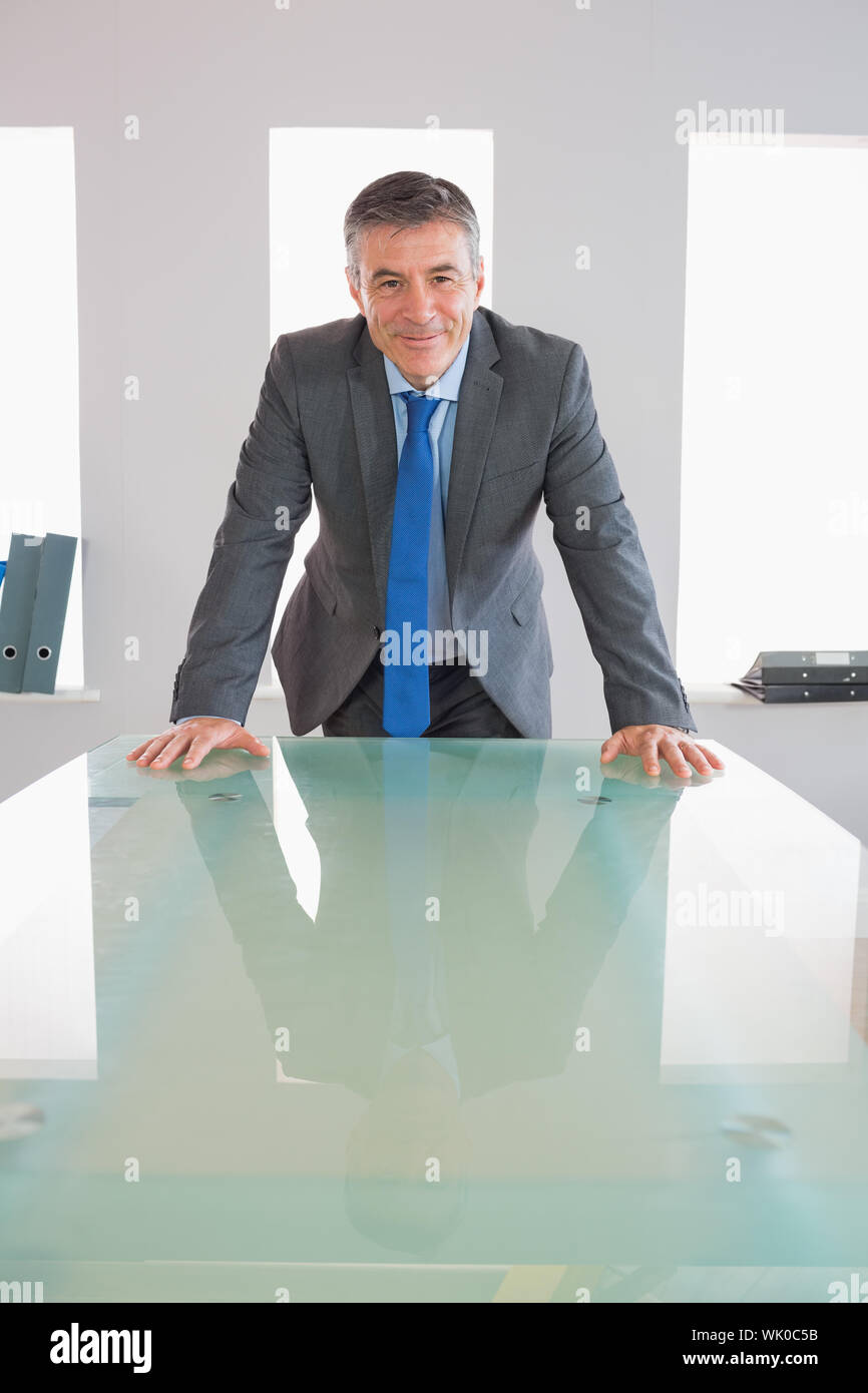 Laughing businessman standing in front of 24 Banque D'Images