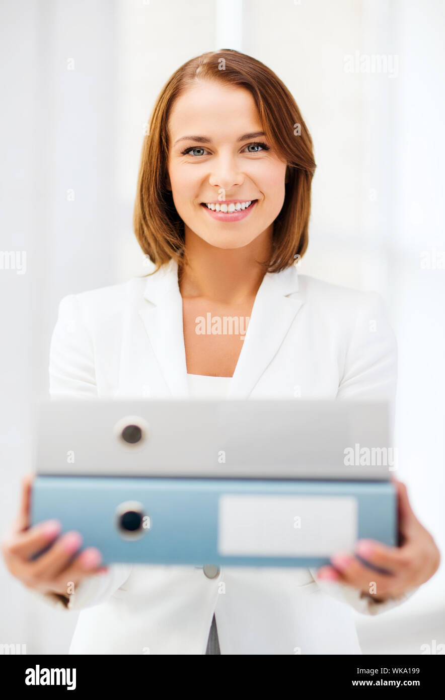 Businesswoman with folders in office Banque D'Images