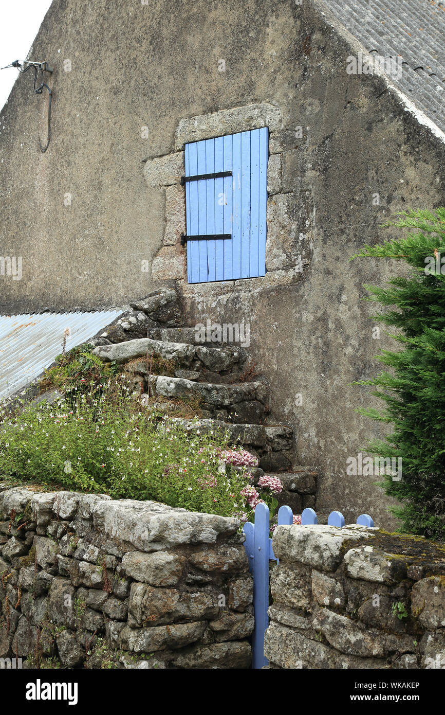 Fenêtre de grenier à volets bleus et marches sur la maison à Kerno sur l'Ile aux Moines dans le Golfe du Morbihan, en Grande-Bretagne, en France Banque D'Images