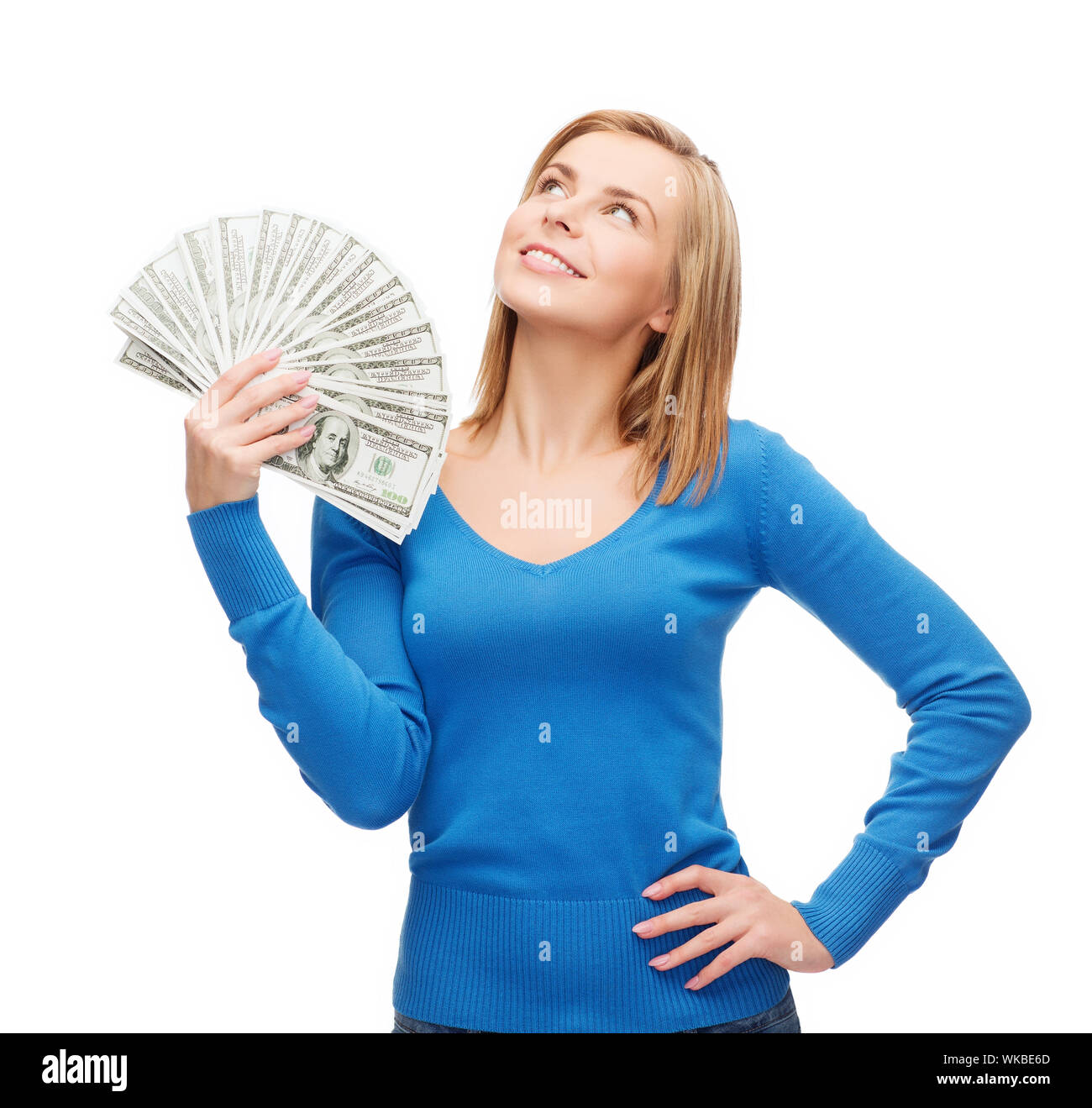 Jeune fille souriante avec de l'argent comptant en dollars Banque D'Images
