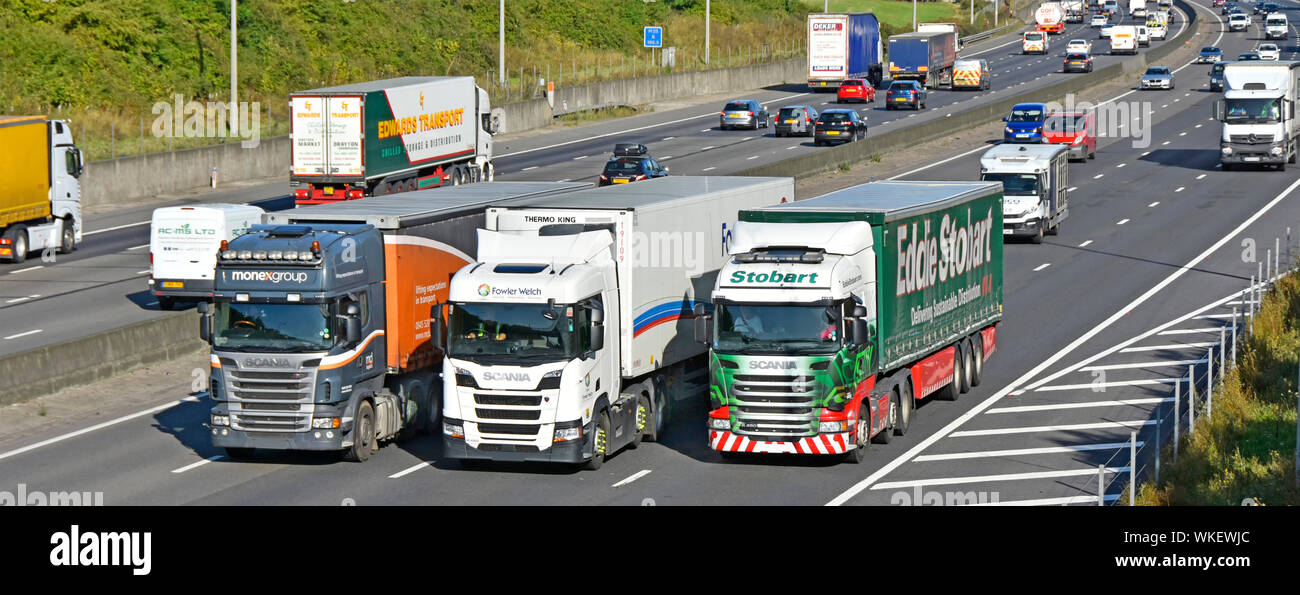 Camion Poids lourds de la chaîne d'approvisionnement des chauffeurs de camion à cabine des véhicules remorque articulé les dépassements dans des camions camions trafic autoroute à quatre voies occupé England UK Banque D'Images