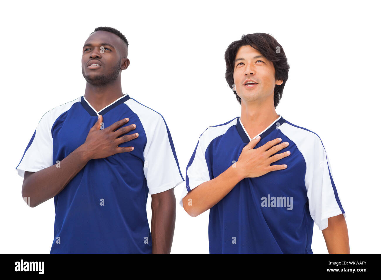 Les joueurs de football en bleu avec les mains de coeur sur fond blanc Banque D'Images