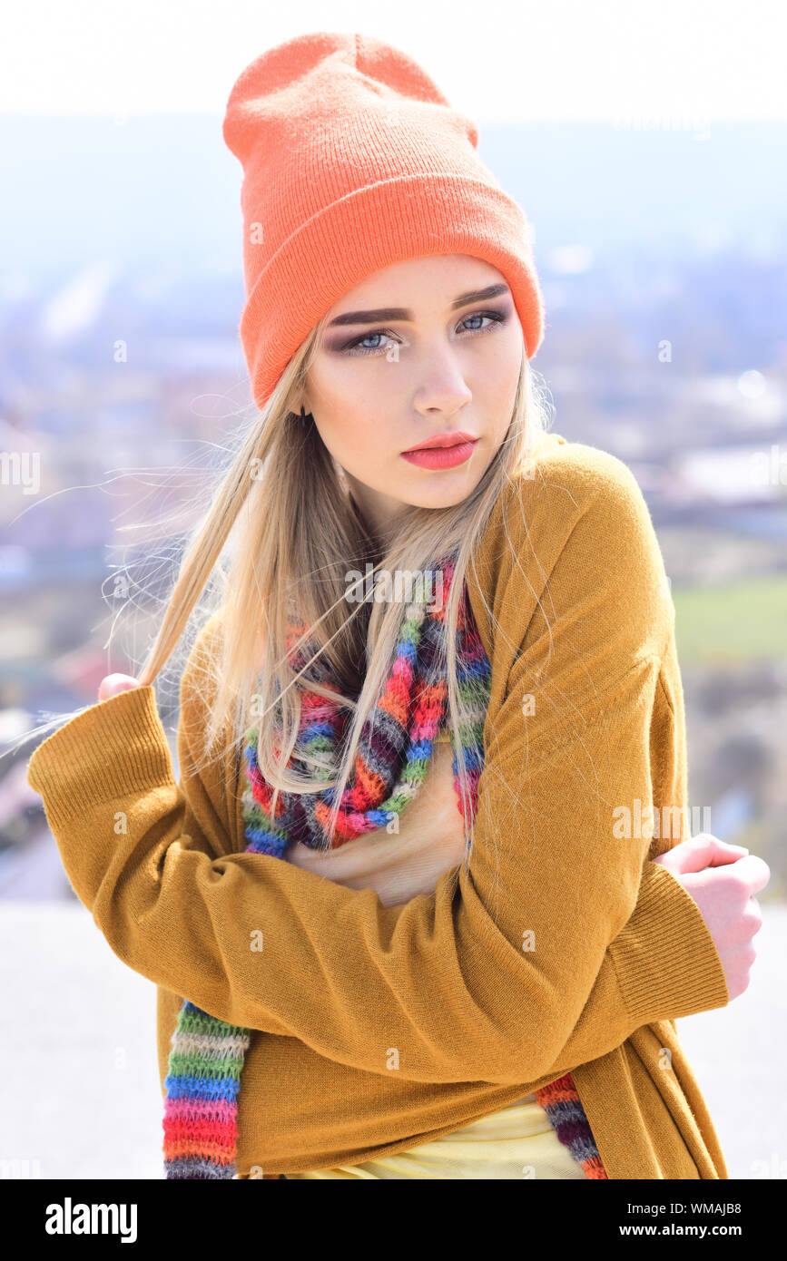 Jeune hipster avec cheveux blonds portant chapeau orange et écharpe  multicolore à l'extérieur. posant Street Fashion Concept Photo Stock - Alamy