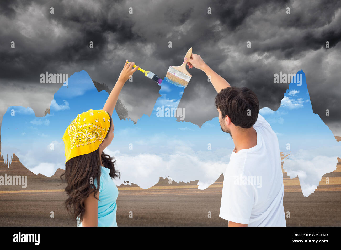 Image composite de happy young couple painting le ciel de l'obscurité à la lumière Banque D'Images