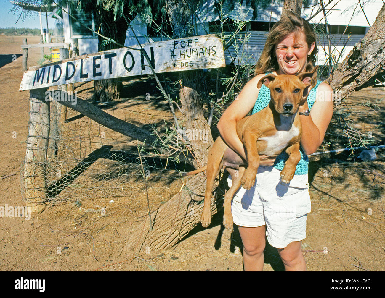 Un ranch femme et son chien à l'avant de leur petite maison dans la petite communauté de l'outback, l'Australie, Middleton au Queensland Banque D'Images