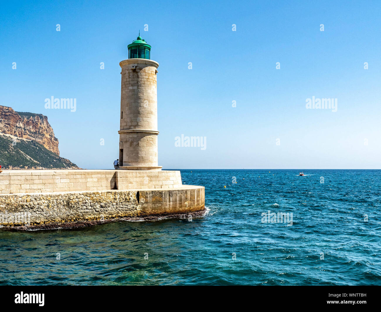 Les navires dans le port phare guidant à Cassis, France, sur la côte d'Azur. Banque D'Images