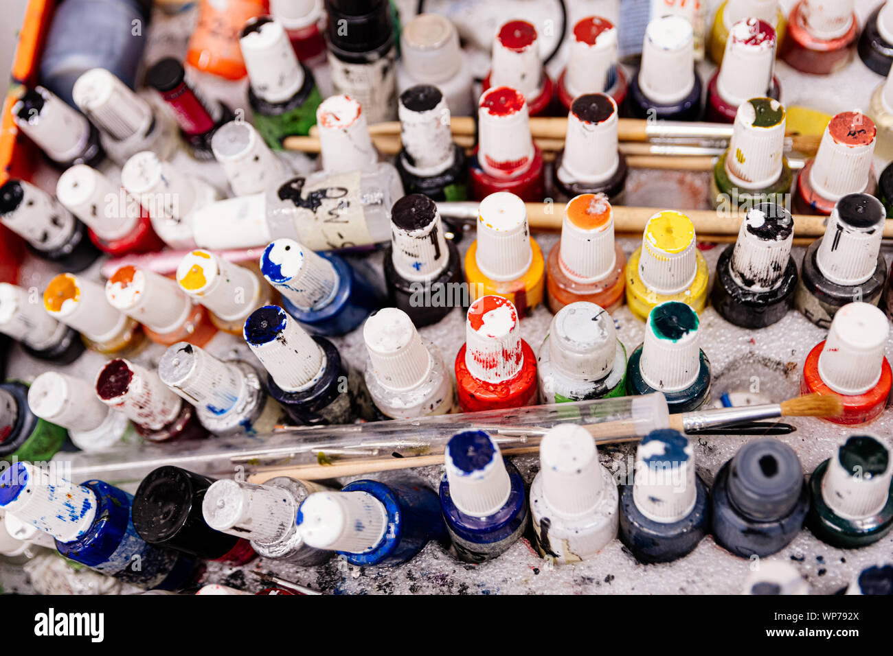 Peinture colorée sale bouteilles et pinceaux. La palette de l'artiste. Banque D'Images