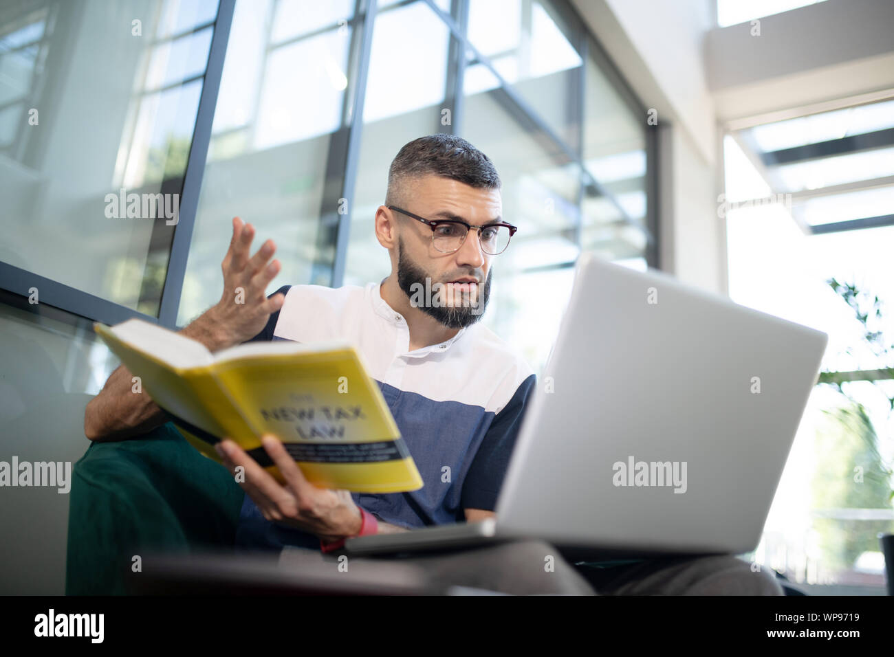 Sentiment d'affaires lors de la lecture émotionnelle livre Droit fiscal Banque D'Images