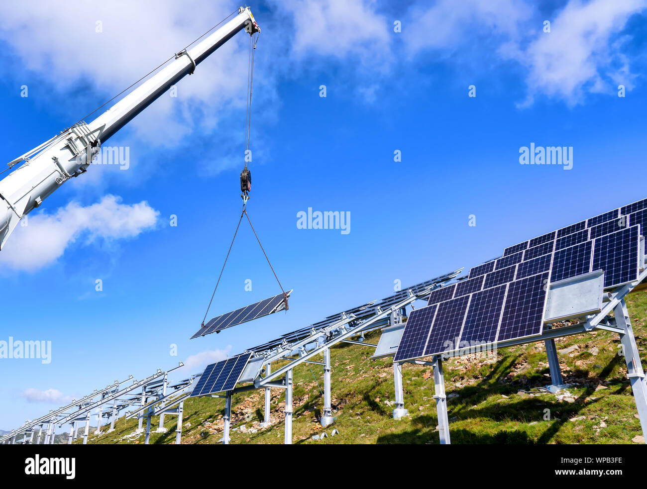 Remontées mécaniques de grue mobile une cellule solaire sur le système de fixation de la construction solaire Banque D'Images