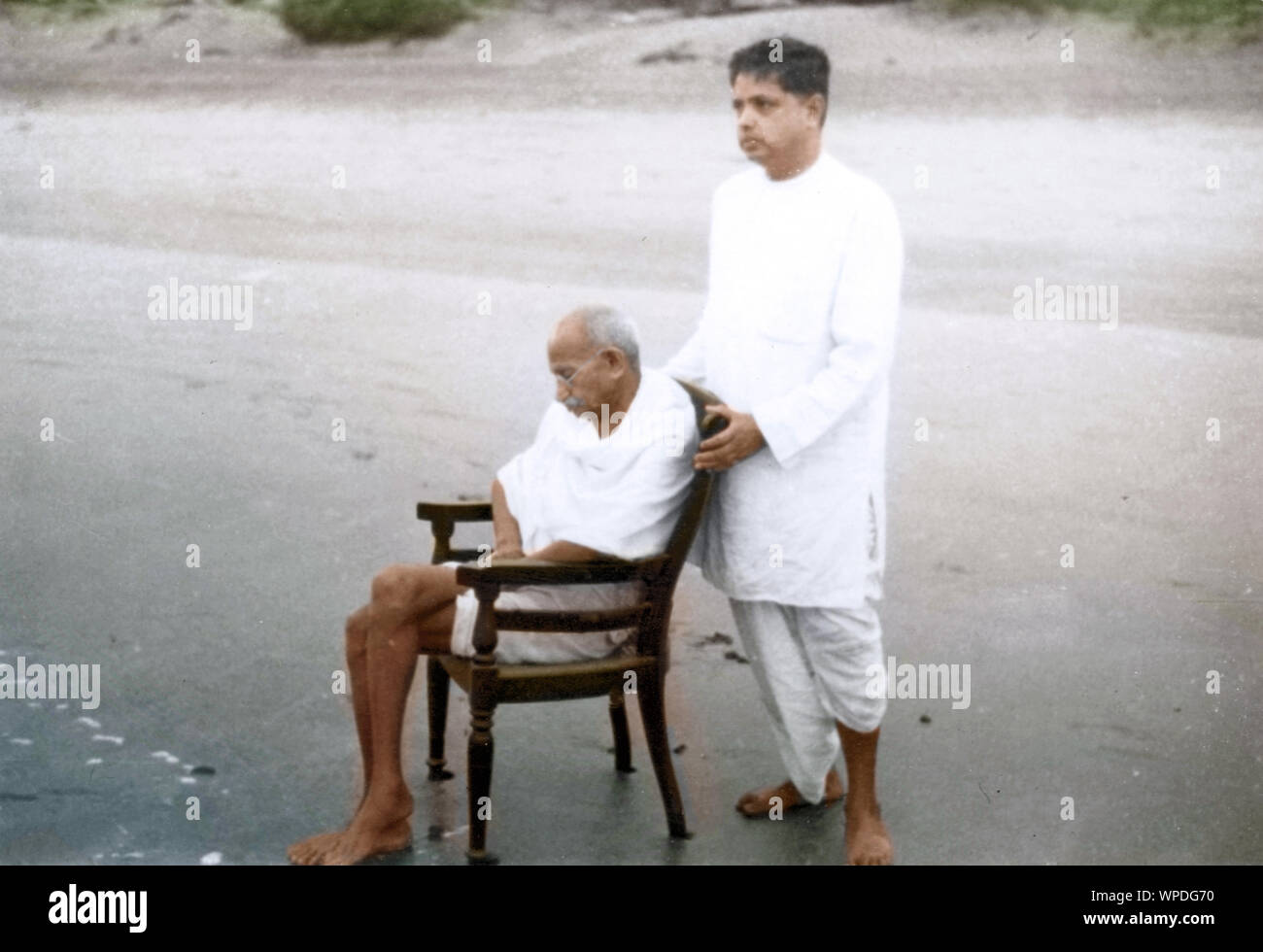 Mahatma Gandhi assis sur la chaise et Devdas Gandhi sur Juhu Beach, Bombay, Mumbai, Inde, Asie, mai 1944 Banque D'Images