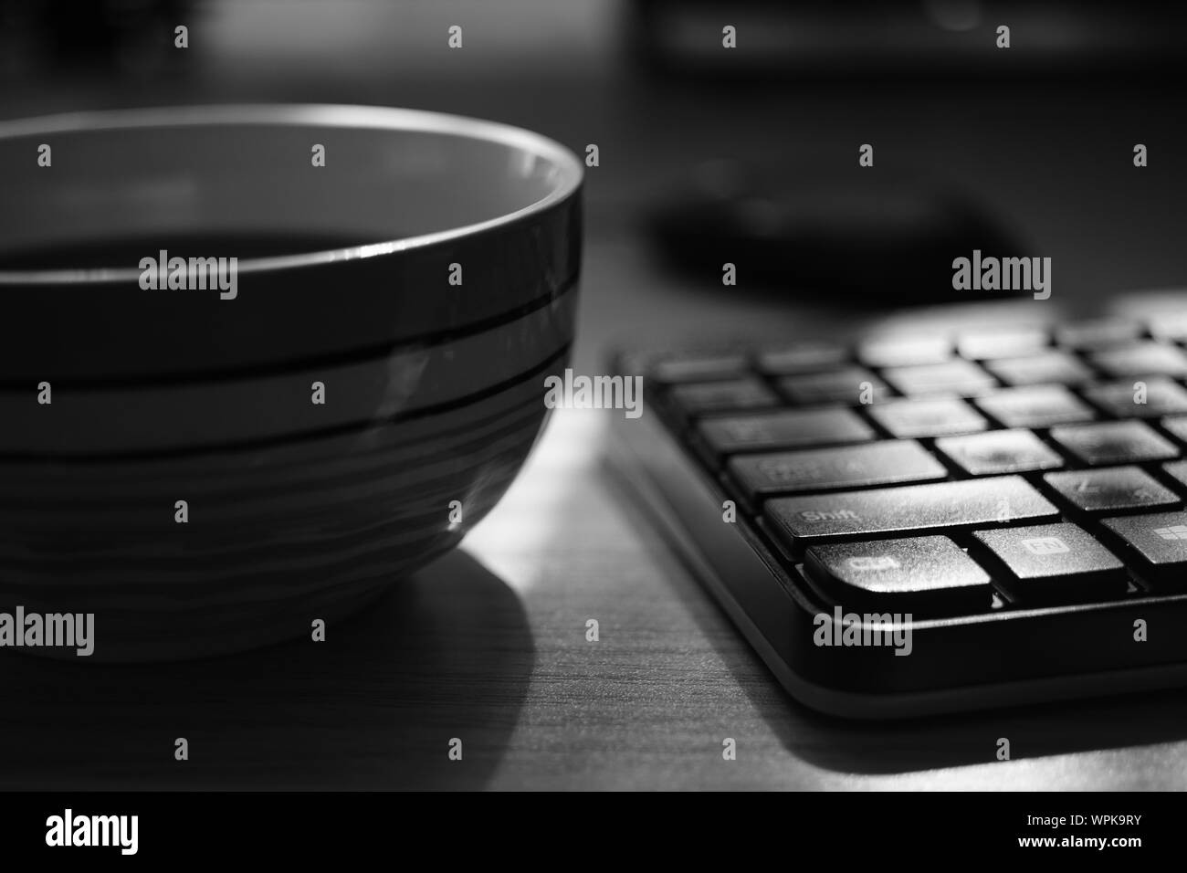 Espace de travail indépendant, tasse de thé et d'un clavier, de l'environnement de travail, selective focus, photo en noir et blanc. Banque D'Images