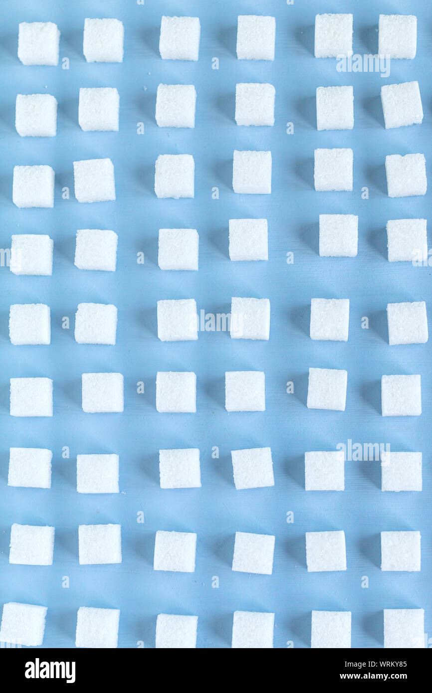 Motif répétitif avec des morceaux de sucre, fond bleu, papier peint. selective focus Banque D'Images