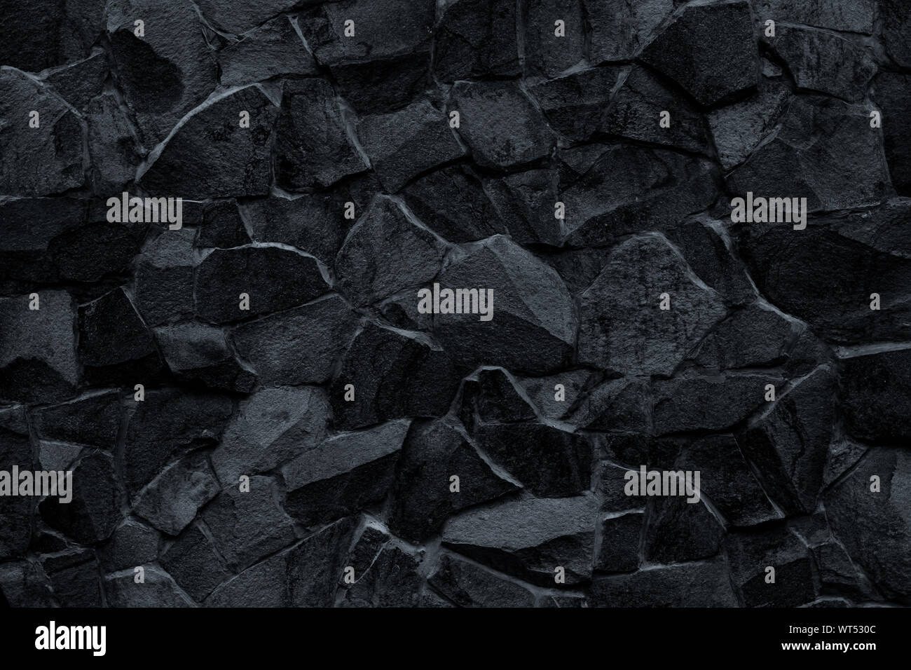 Mur de pierre noire. Mosaïque de briques dans le style rétro et moderne. Rock sombre texture, modèle mur de briques. Grunge gris surface. En moyenne géométrique fac Banque D'Images