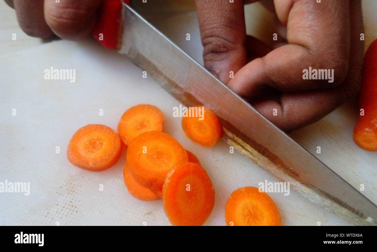 Femme cuisinière carotte fraîche coupe légumes pour la cuisson à la maison cuisine Banque D'Images
