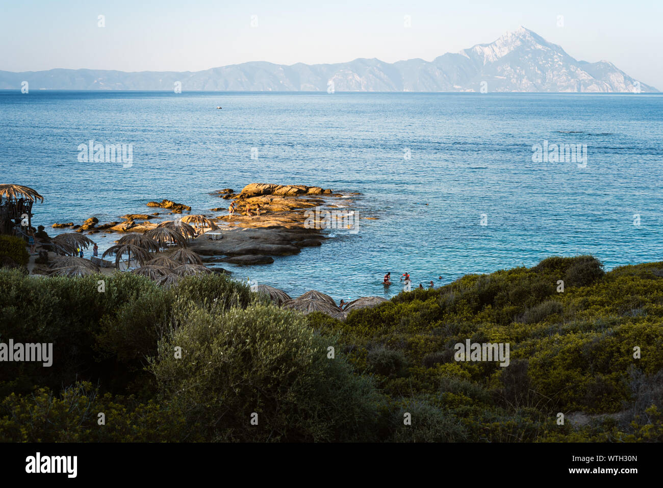 TIGANIA BEACH, GRÈCE - août 23, 2019 : les touristes appréciant Tigania beach à Sithonia, Grèce en vue du mont Athos Banque D'Images