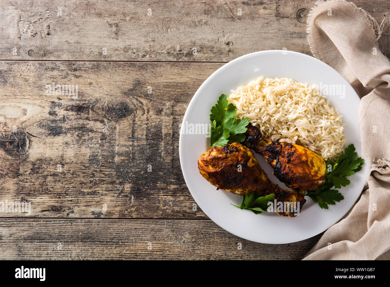 Poulet tandoori grillés avec du riz basmati en plaque sur les tables en bois. Vue d'en haut. Copy space Banque D'Images