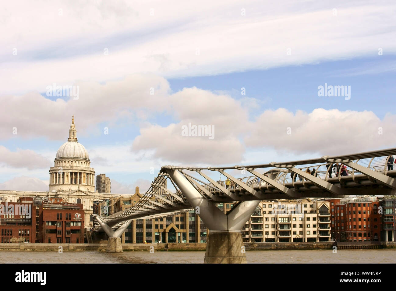 Les visiteurs et les passants marchant sur le pont du millénaire avec l'arrière de la cathédrale St Paul à Londres. Banque D'Images