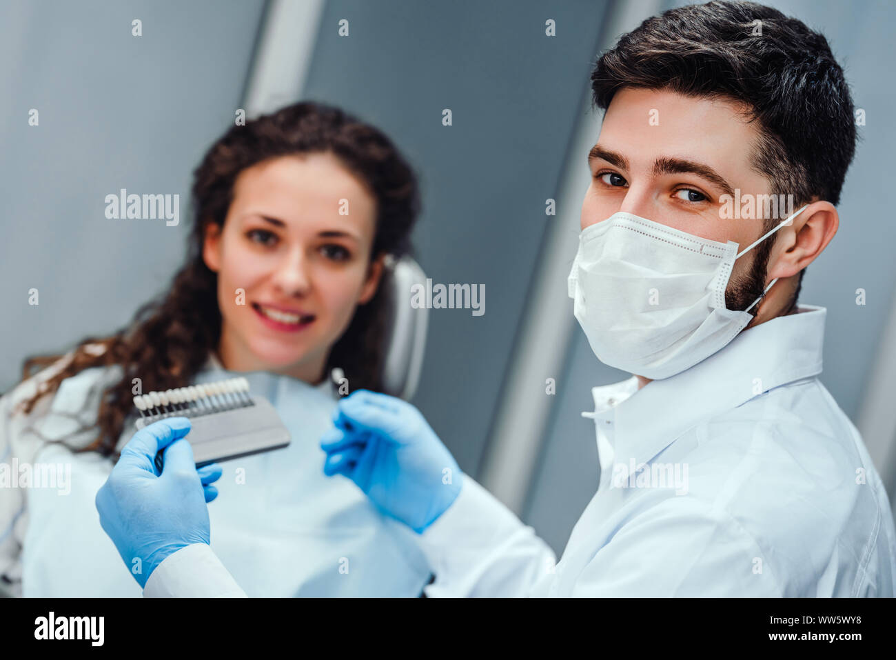 Contrôle et sélection de dentiste de couleur des dents de la jeune femme regardant la caméra Vue en gros plan. focus sélectif. Banque D'Images