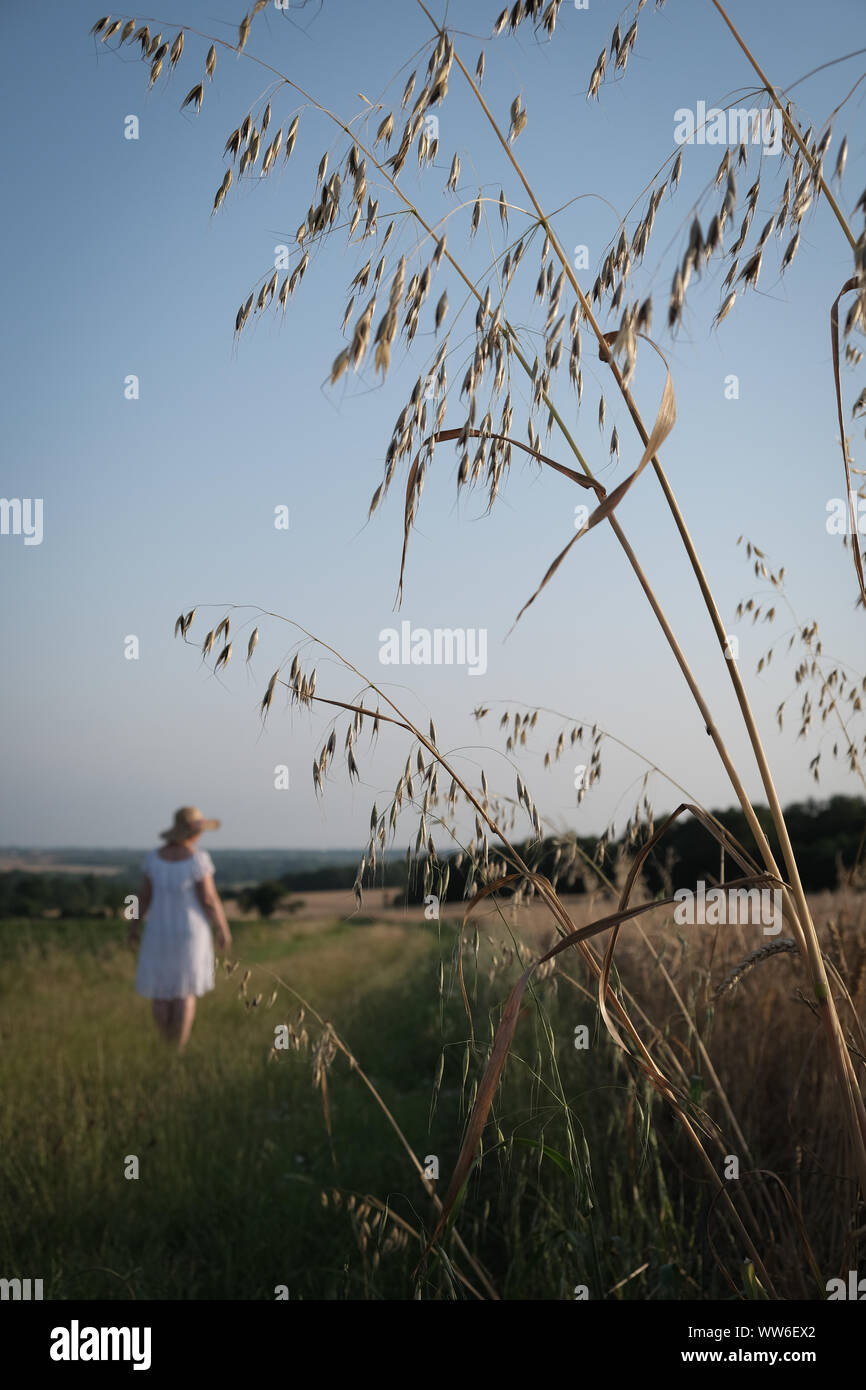 Woman walking in rural landscape, France Banque D'Images