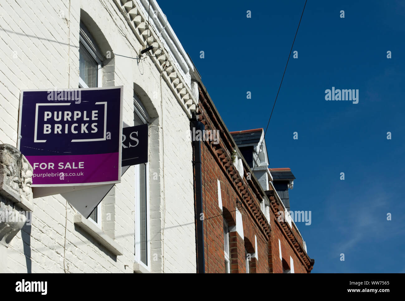 À vendre signe de la succession de l'agent pourpre briques sur une maison du 19e siècle à Twickenham, Middlesex, Angleterre Banque D'Images