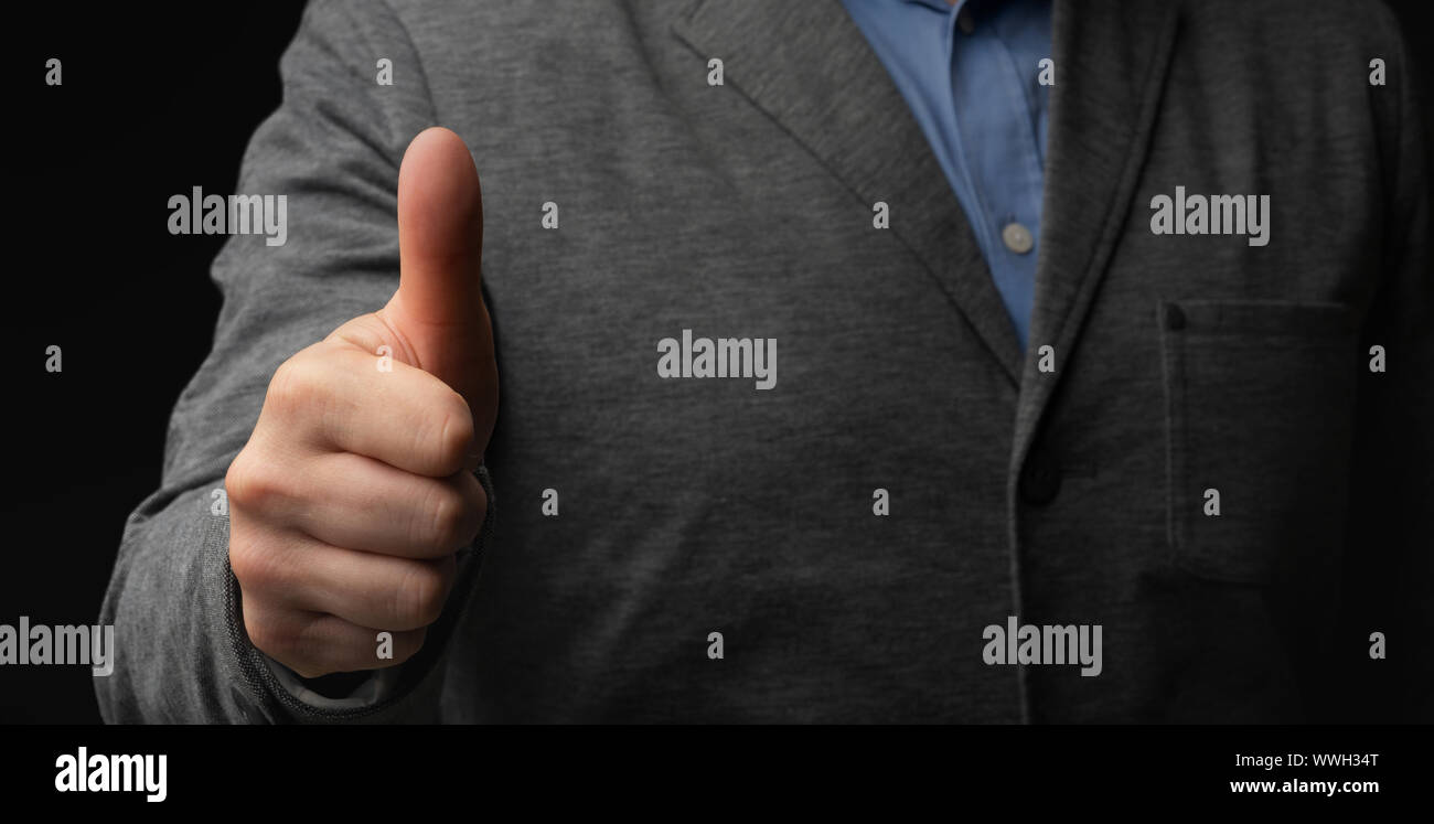 Caucasian businessman in suit showing thumb up geste Banque D'Images