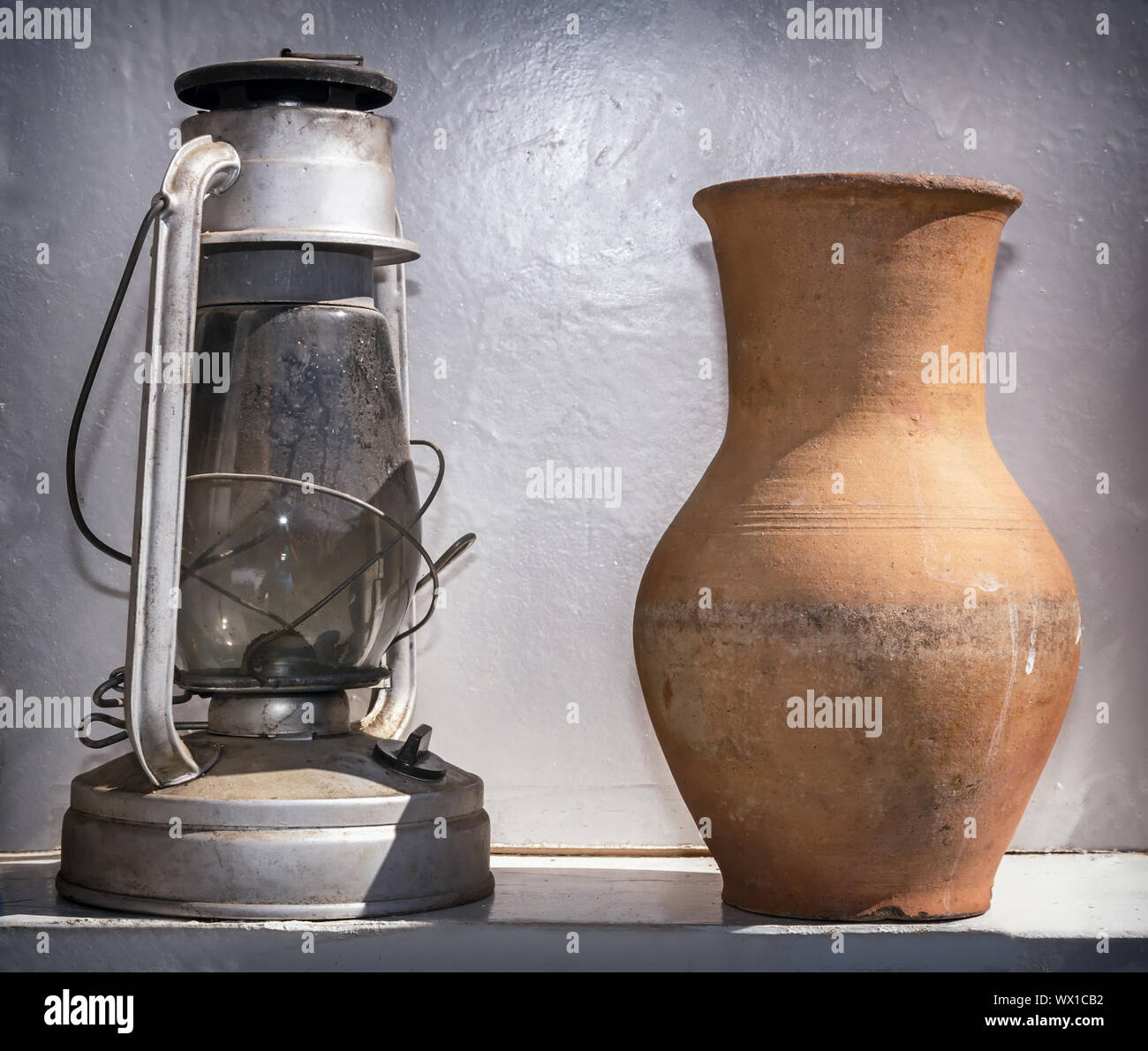 Des objets anciens de la vie quotidienne : une lampe au kérosène et une cruche. Banque D'Images