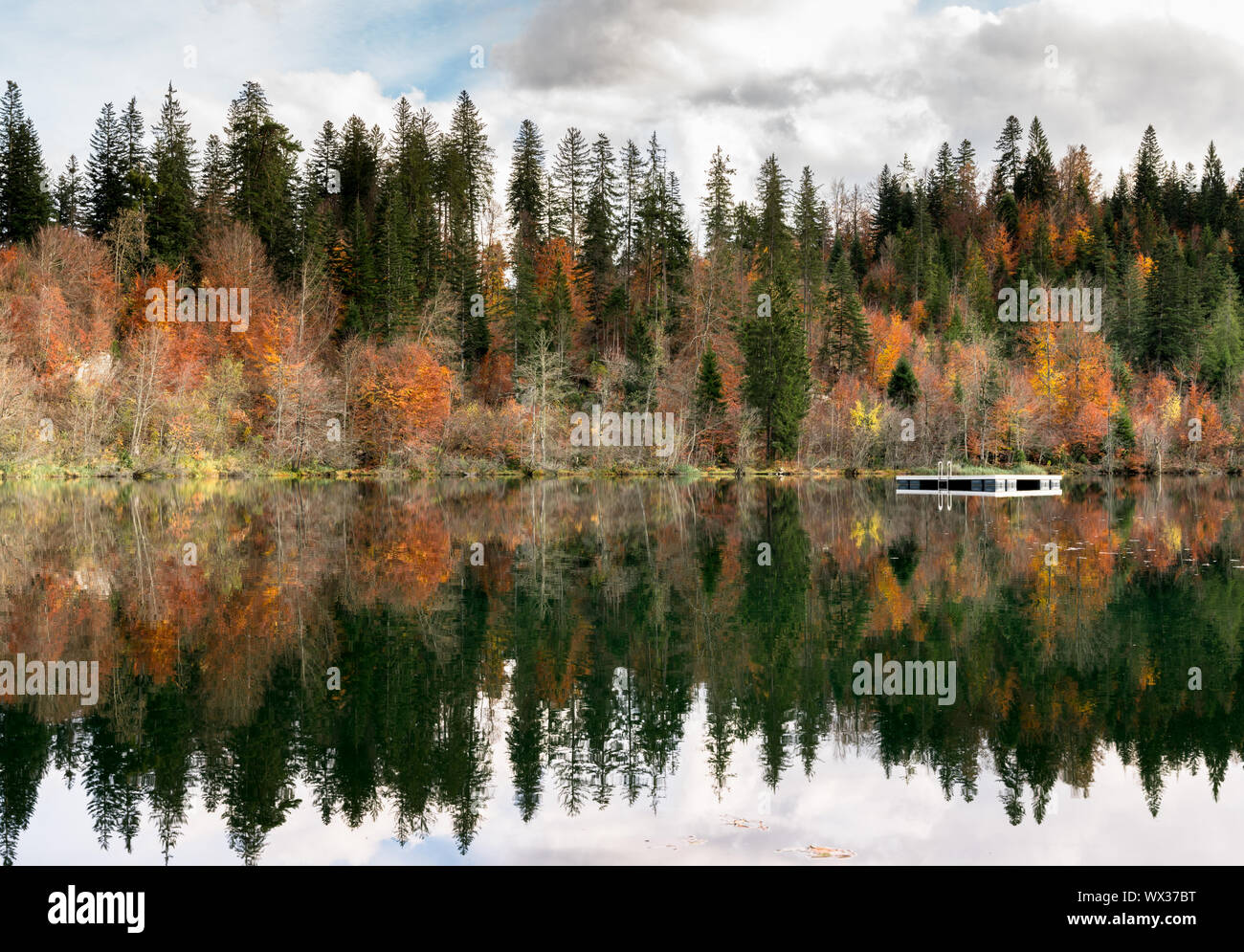 La couleur de l'automne et le feuillage des forêts entourent une paysage lac de montagne idyllique dans les Alpes de Suisse Banque D'Images