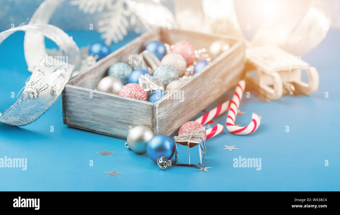 Boules de Noël rose et bleu et papier d'emballage pour les cadeaux avec cadre photo ancien sur table en bois Banque D'Images