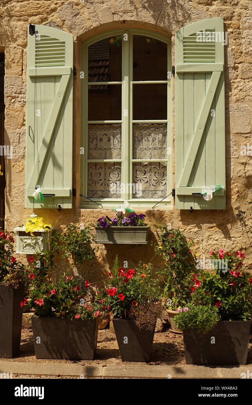 Une maison en pierre de la province française d'avant les plantes en pot, Fenêtre et volets verts Banque D'Images