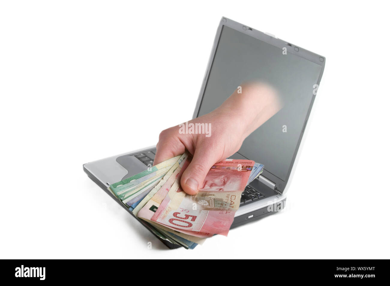 Une main qui sort de l'écran d'un ordinateur avec l'argent canadien. Banque D'Images