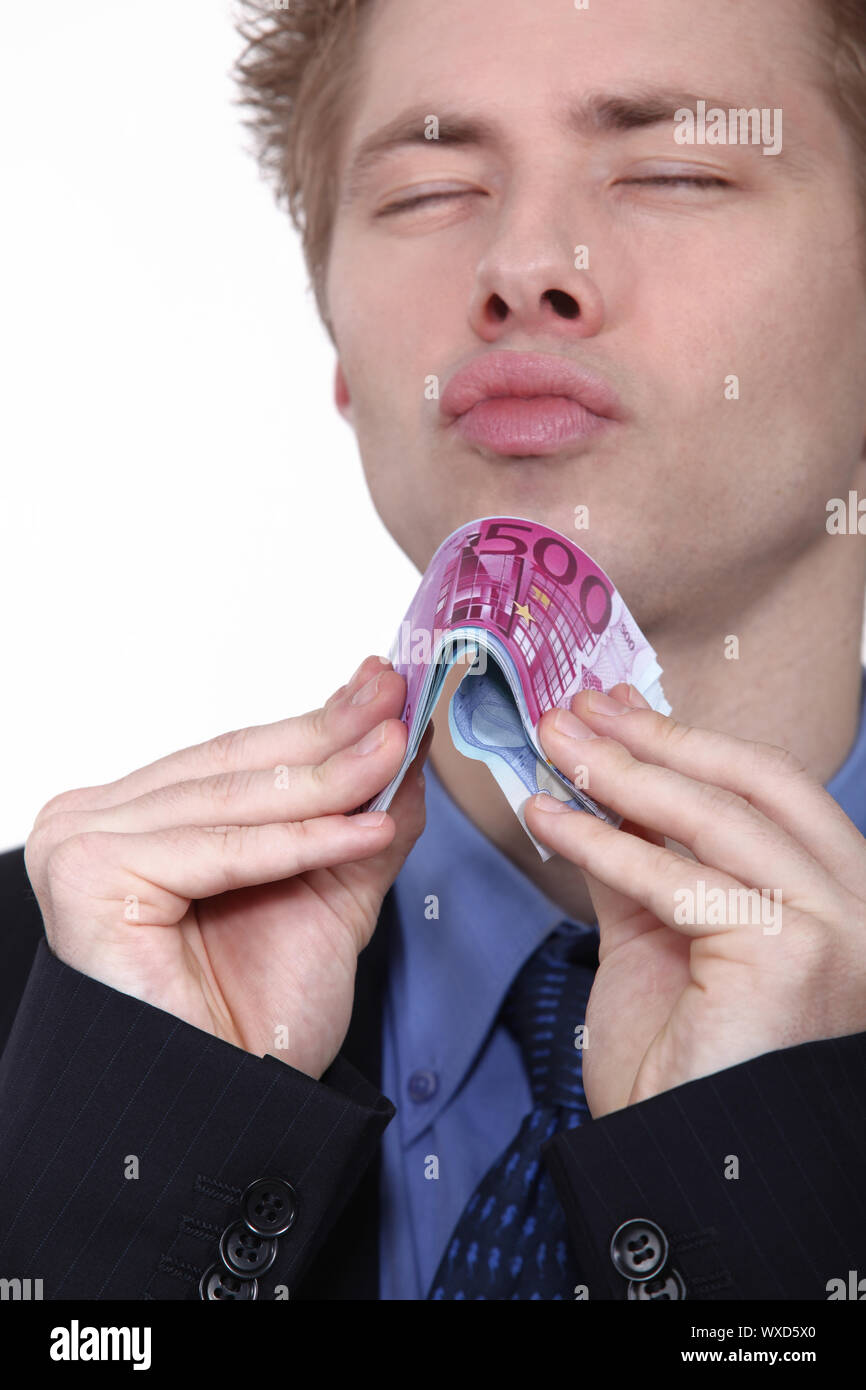 Young man holding bank notes Banque D'Images