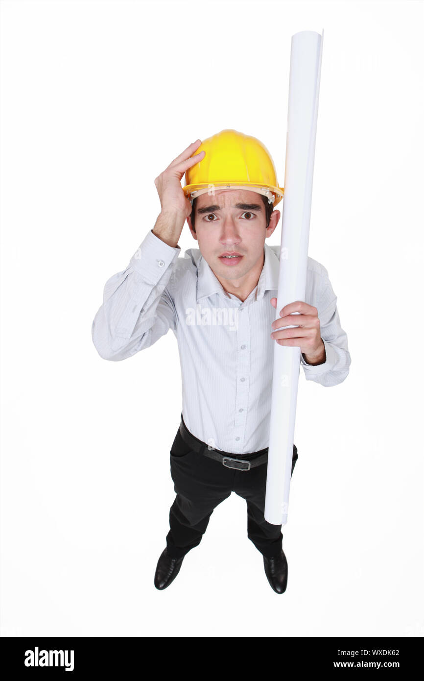 Ingénieur paniqué tenant un tapis d'encombrement Banque D'Images