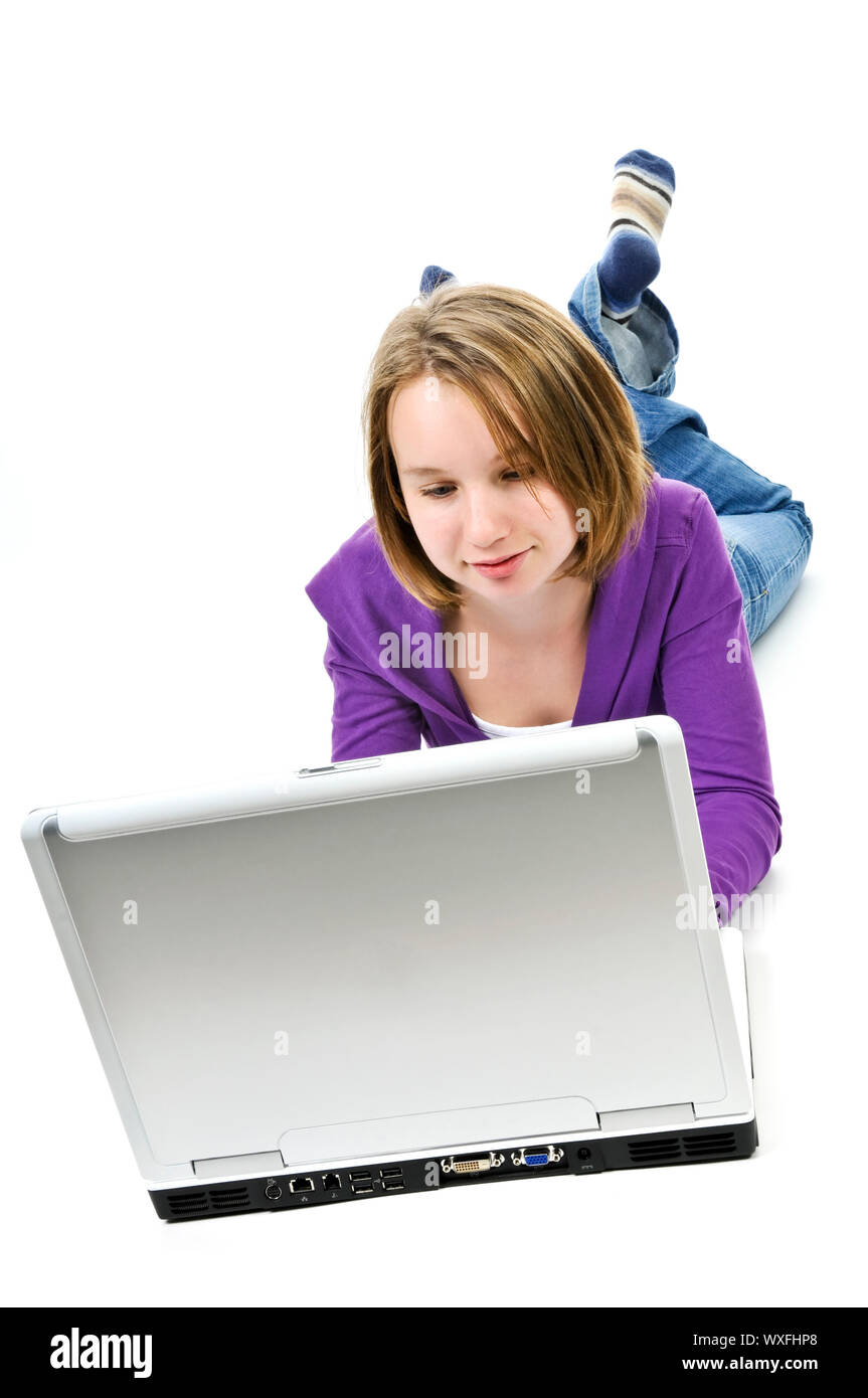 Young Girl lying down with laptop computer Banque D'Images