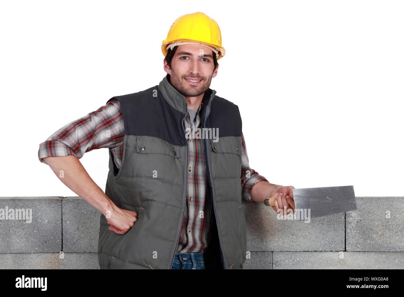 Mason tenant une truelle Banque D'Images