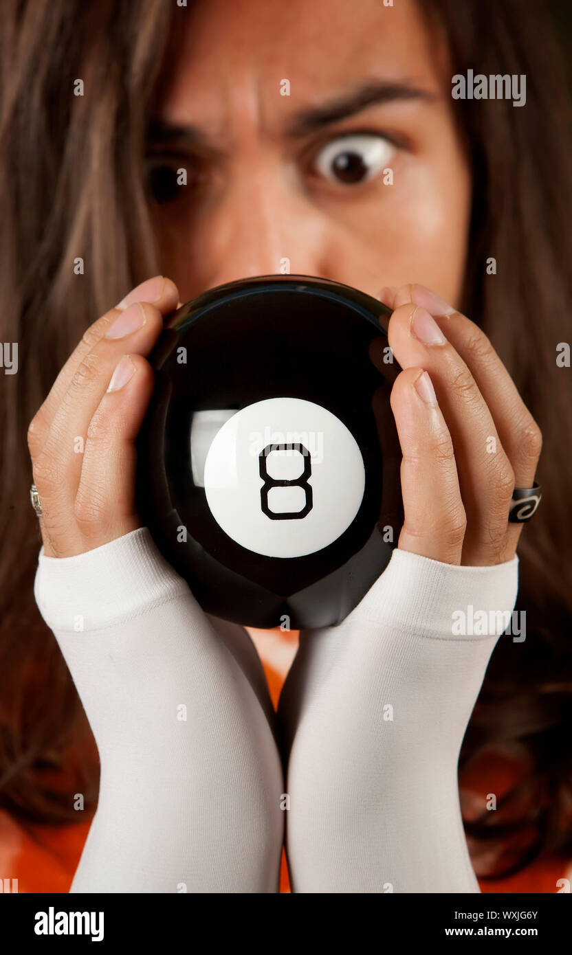 L'homme regardant la prévision sur un magic ball jouet Banque D'Images