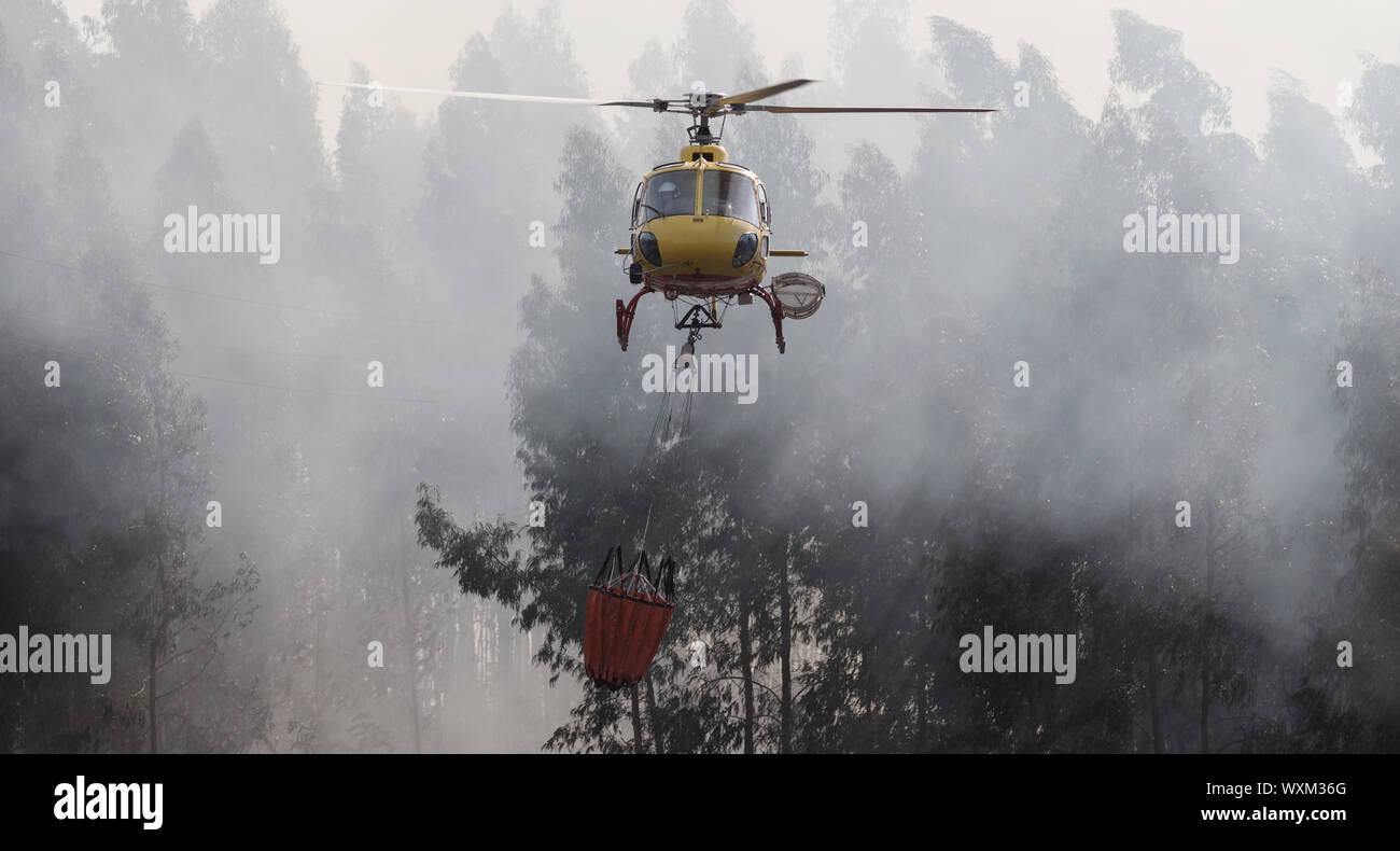 Povoa de Lanhoso, 12 octobre 2017, hélicoptère pompier de protection civile CS-HMI, portugais, larguer de l'eau lors d'un incendie. Banque D'Images