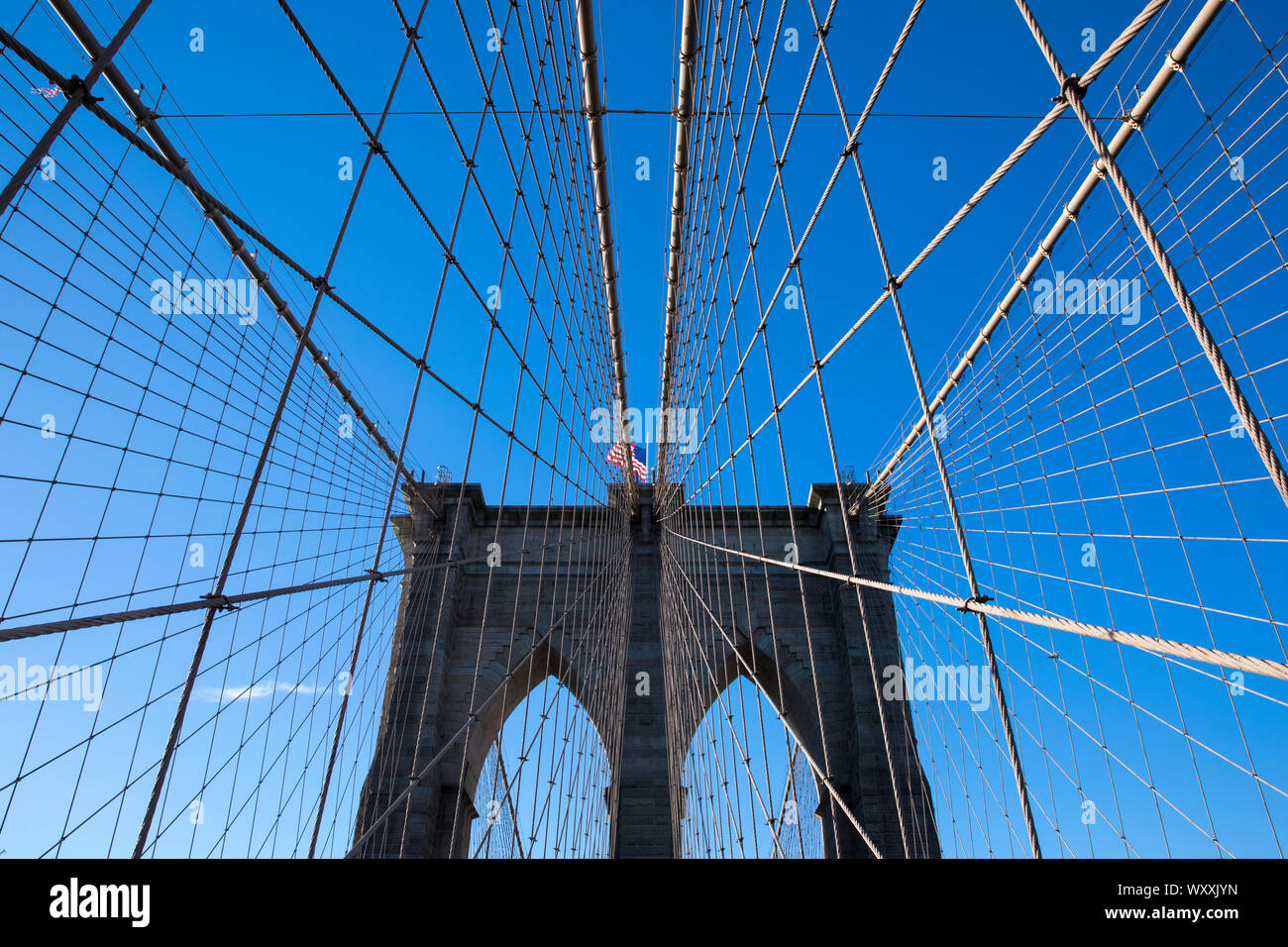 Piers et le fil prend en charge du pont de Brooklyn et Stars and Stripes drapeau américain, New York City Banque D'Images