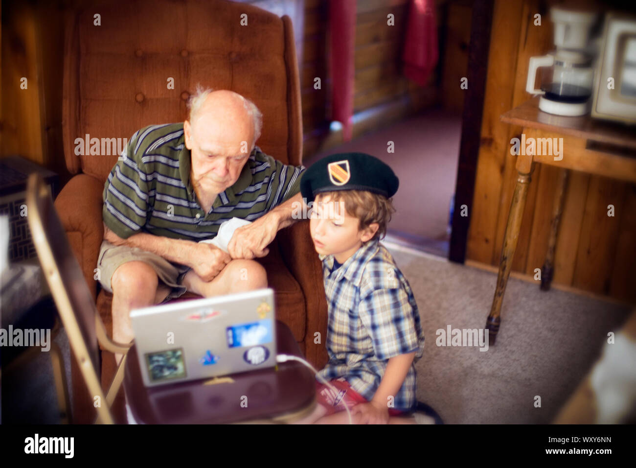 Vue d'un petit garçon et son grand-père à la recherche d'un ordinateur portable. Banque D'Images