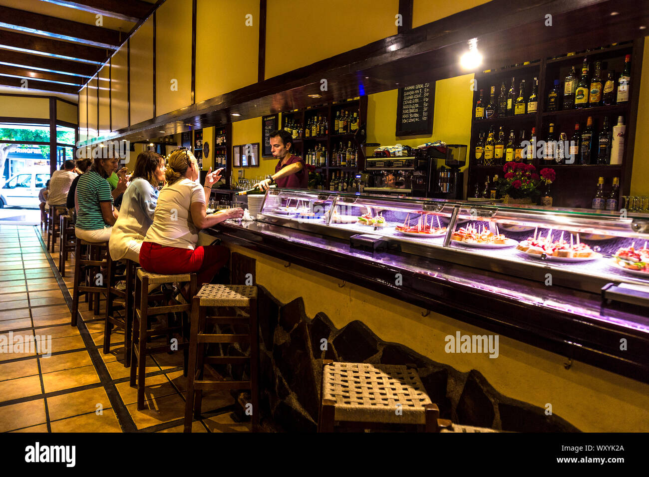 Personnes assises au comptoir d'un bar à tapas, restaurant El Zaguan, Ibiza, Espagne Banque D'Images