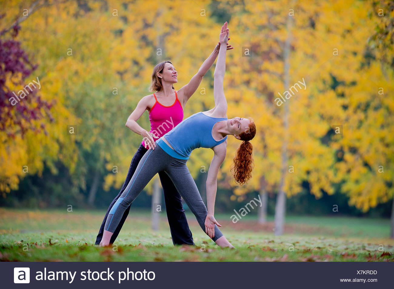 Professeur de Yoga l'enseignement aux jeunes femme en forêt Banque D'Images