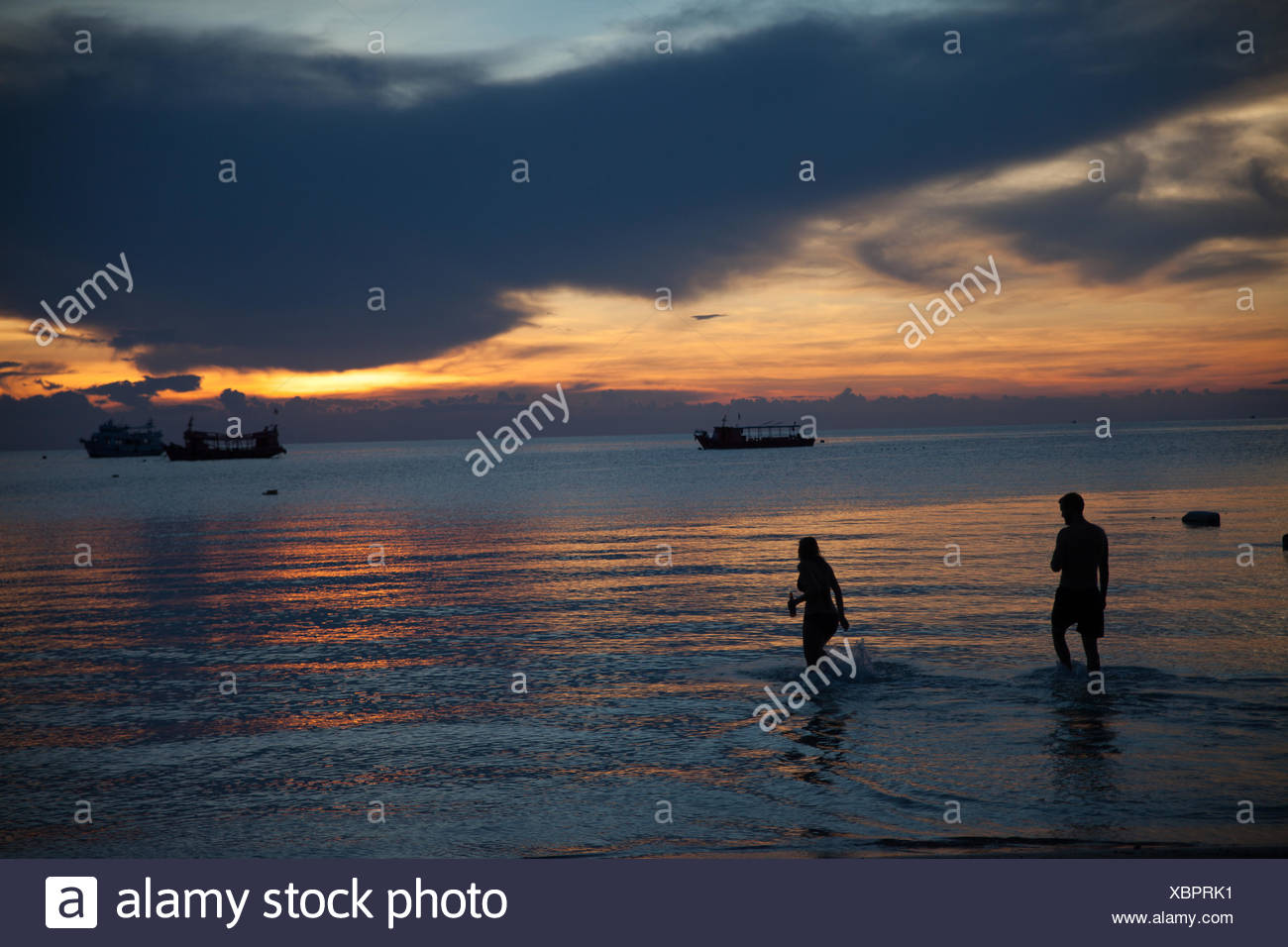 Silhouette Couple En Train De Marcher Dans La Mer Contre