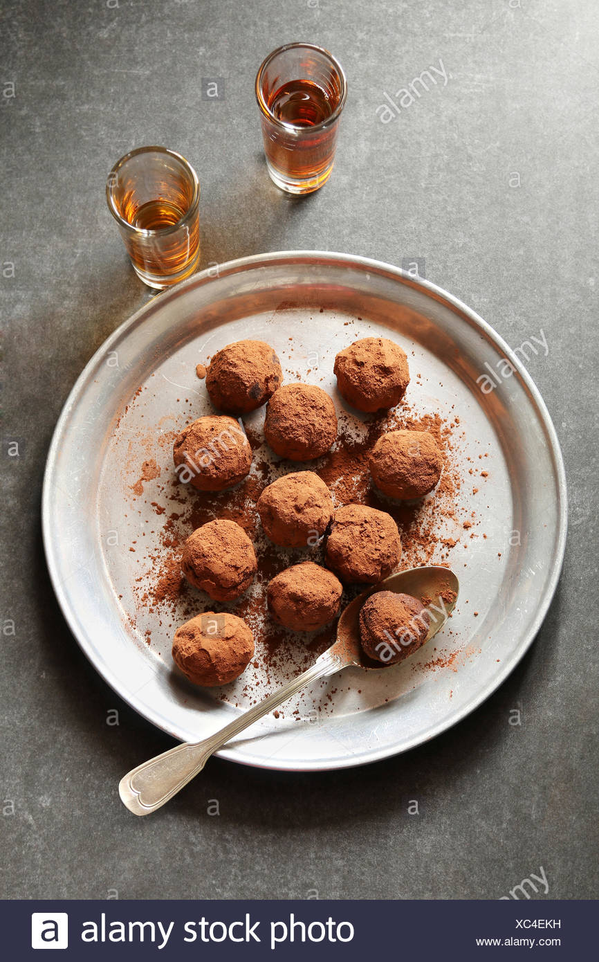 Truffes au chocolat sur une plaque en aluminium, avec 2 verres de liqueur sur arrière-plan Banque D'Images